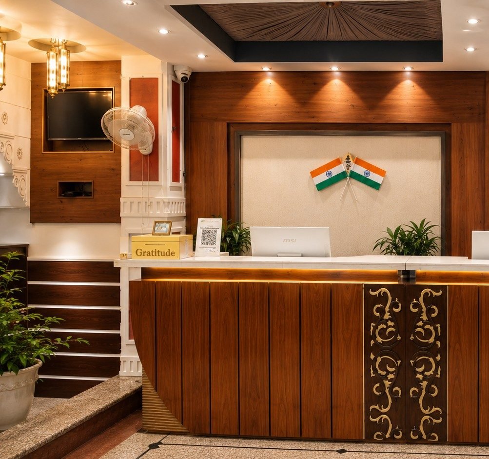 Reception desk at Hotel HVH Kashi Vishwanath with warm wood panelling and brass lanterns